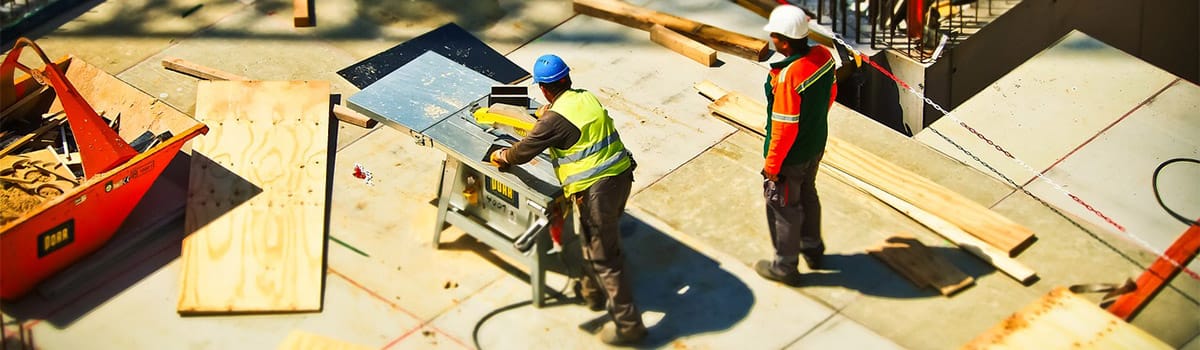 workers cutting lumber