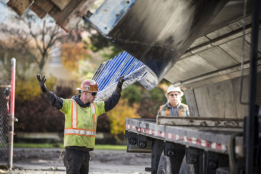 worker oversees materials unload