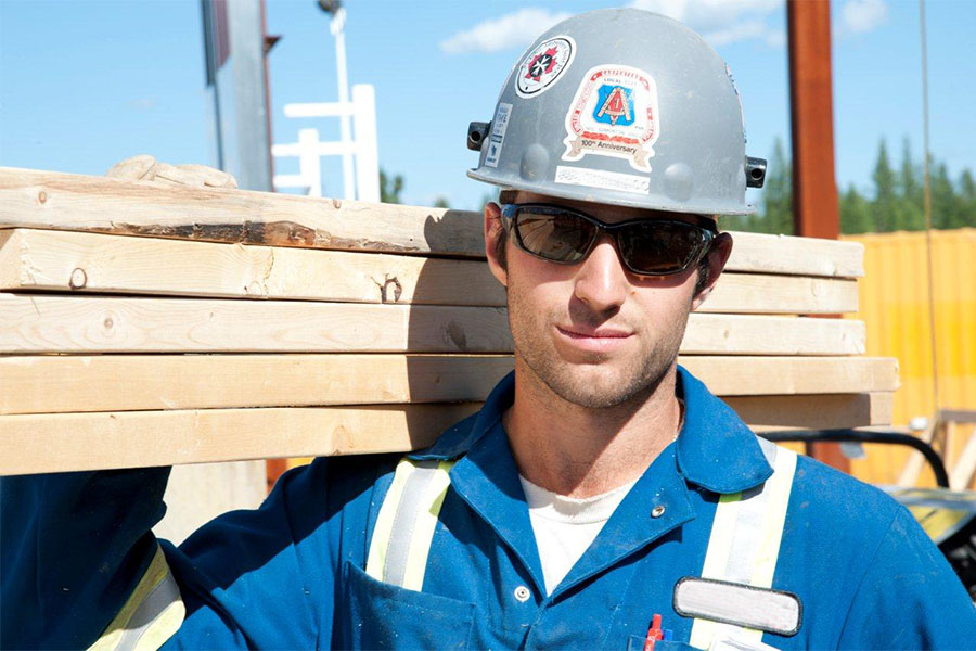 bfi employee holding lumber